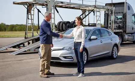 Vehicle owner beside their delivered car in McPherson, Kansas, United States