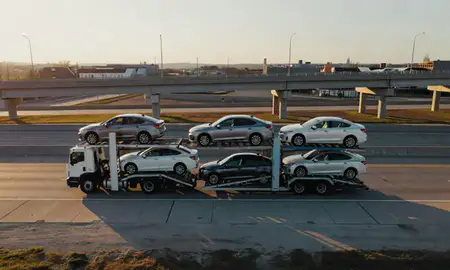 Car transporter with the Bowling Green, Kentucky, United States skyline behind it