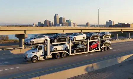 Car transporter with the Louisville, Kentucky, United States skyline behind it