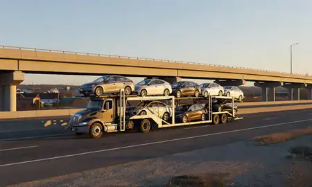 Car transporter with the Nicholasville, Kentucky, United States skyline behind it