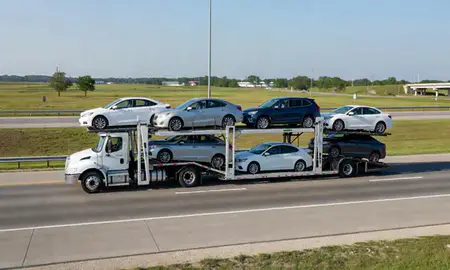 Multi-level car carrier on the highway to Central, Louisiana, United States