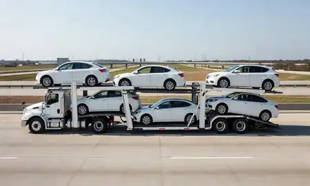 Multi-level car carrier on the highway to Kenner, Louisiana, United States