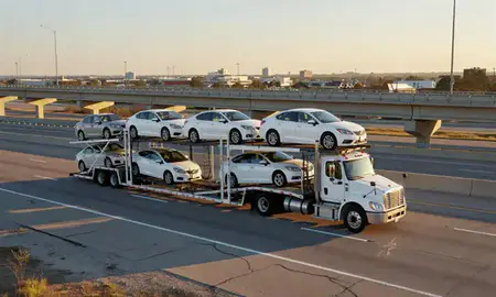 Car transporter with the Lafayette, Louisiana, United States skyline behind it