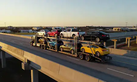 Car transporter with the Lake Charles, Louisiana, United States skyline behind it