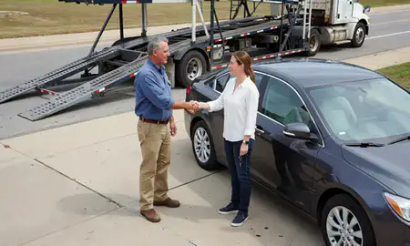 Vehicle owner beside their delivered car in Monroe, Louisiana, United States
