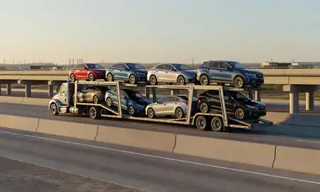 Car transporter with the Sulphur, Louisiana, United States skyline behind it