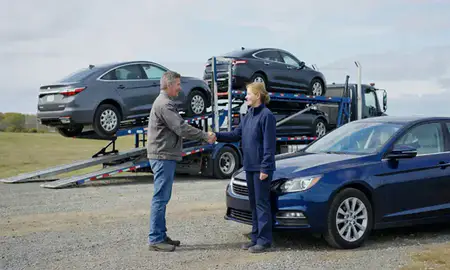Vehicle owner beside their delivered car in Maine, United States
