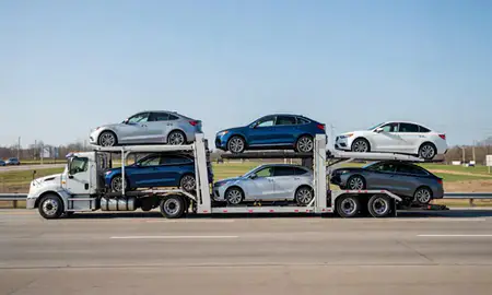 Multi-level car carrier on the highway to Auburn, Maine, United States