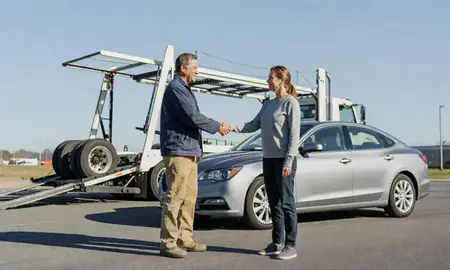 Vehicle owner beside their delivered car in Auburn, Maine, United States