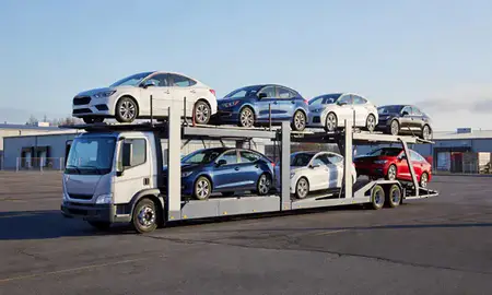 Car transporter loaded with vehicles in Auburn, Maine, United States