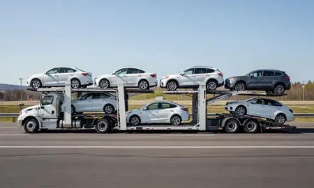 Multi-level car carrier on the highway to Augusta, Maine, United States