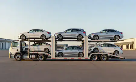 Car transporter parked in an industrial area of Augusta, Maine, United States