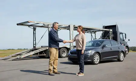 Vehicle owner beside their delivered car in Bath, Maine, United States