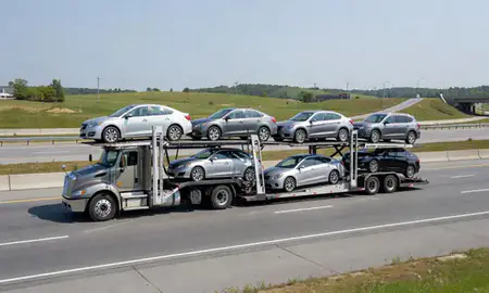 Multi-level car carrier on the highway to Biddeford, Maine, United States