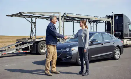 Vehicle owner beside their delivered car in Brewer, Maine, United States