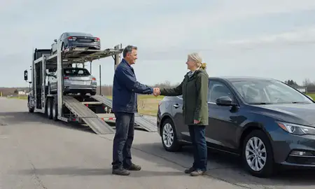 Vehicle owner beside their delivered car in Calais, Maine, United States