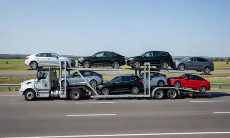 Multi-level car carrier on the highway to Caribou, Maine, United States