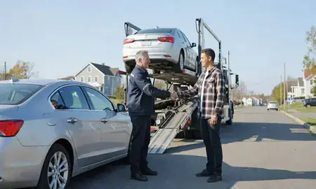 Vehicle owner beside their delivered car in Ellsworth, Maine, United States