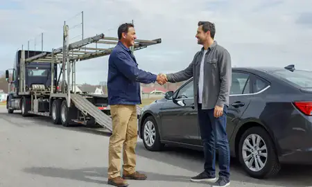 Vehicle owner beside their delivered car in Gardiner, Maine, United States