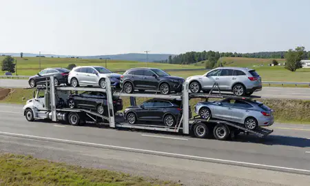 Multi-level car carrier on the highway to Hallowell, Maine, United States