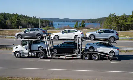 Multi-level car carrier on the highway to Lake Arrowhead, Maine, United States