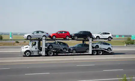 Multi-level car carrier on the highway to Lewiston, Maine, United States
