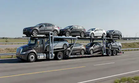 Multi-level car carrier on the highway to Saco, Maine, United States