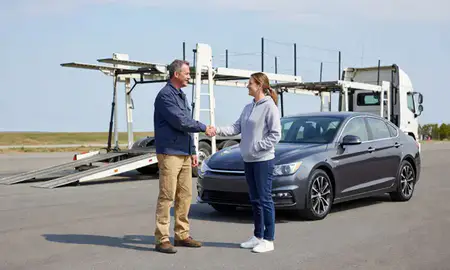 Vehicle owner beside their delivered car in Sanford, Maine, United States
