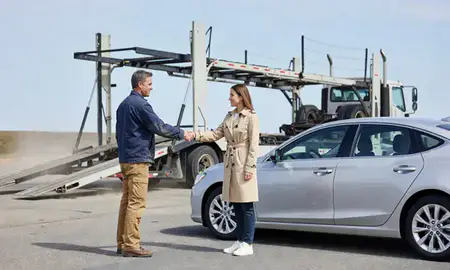Vehicle owner beside their delivered car in South Eliot, Maine, United States