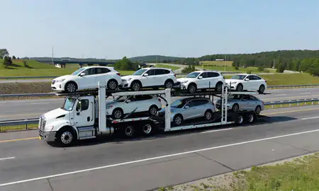 Multi-level car carrier on the highway to Waterville, Maine, United States