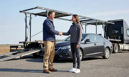 Vehicle owner beside their delivered car in Waterville, Maine, United States