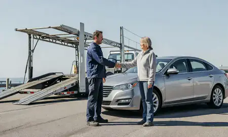 Vehicle owner beside their delivered car in York Harbor, Maine, United States