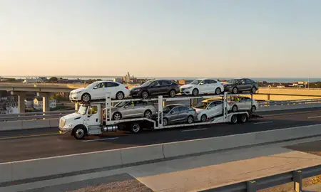 Car transporter with the Annapolis, Maryland, United States skyline behind it