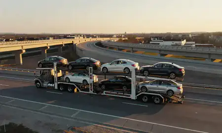 Car transporter with the Clinton, Maryland, United States skyline behind it