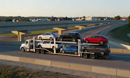 Car transporter with the Ellicott City, Maryland, United States skyline behind it