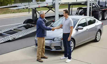 Vehicle owner beside their delivered car in Rockville, Maryland, United States