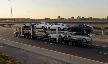 Car transporter with the Rockville, Maryland, United States skyline behind it