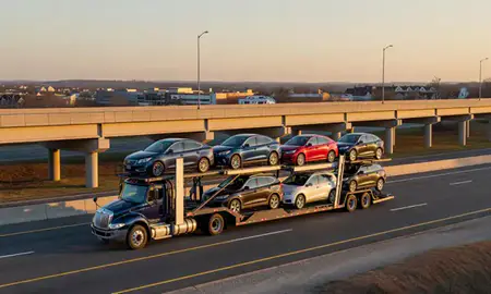 Car transporter with the Wheaton, Maryland, United States skyline behind it