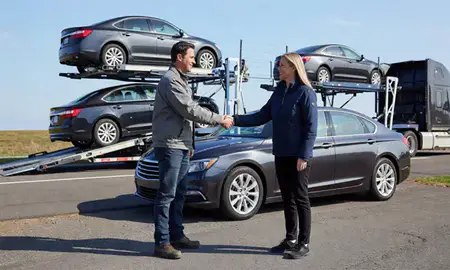 Vehicle owner beside their delivered car in Massachusetts, United States