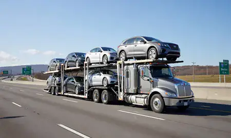 Multi-level car carrier on the highway to Boston, Massachusetts, United States