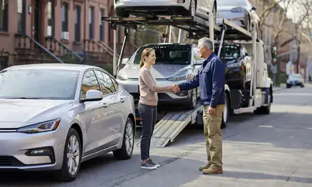 Vehicle owner beside their delivered car in Boston, Massachusetts, United States
