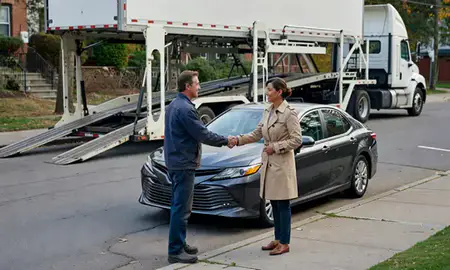 Vehicle owner beside their delivered car in Cambridge, Massachusetts, United States