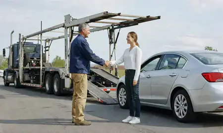 Vehicle owner beside their delivered car in Lawrence, Massachusetts, United States