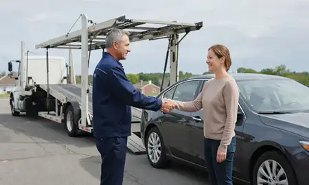 Vehicle owner beside their delivered car in Lynn, Massachusetts, United States