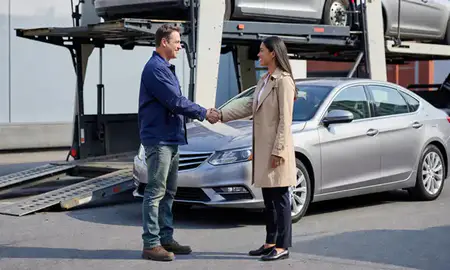 Vehicle owner beside their delivered car in New Bedford, Massachusetts, United States