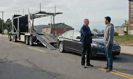 Vehicle owner beside their delivered car in Salem, Massachusetts, United States
