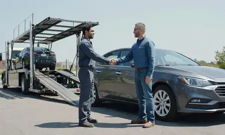 Vehicle owner beside their delivered car in Springfield, Massachusetts, United States