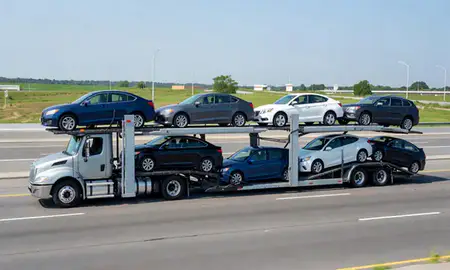 Multi-level car carrier on the highway to Waltham, Massachusetts, United States