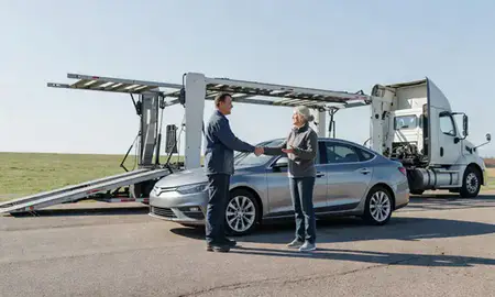 Vehicle owner beside their delivered car in Michigan, United States