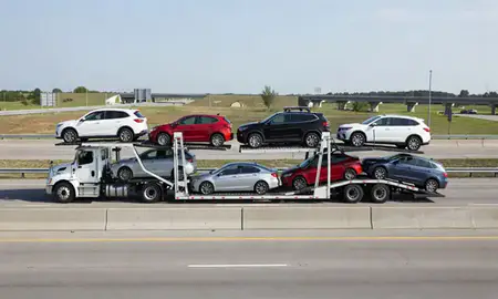 Multi-level car carrier on the highway to Flint, Michigan, United States